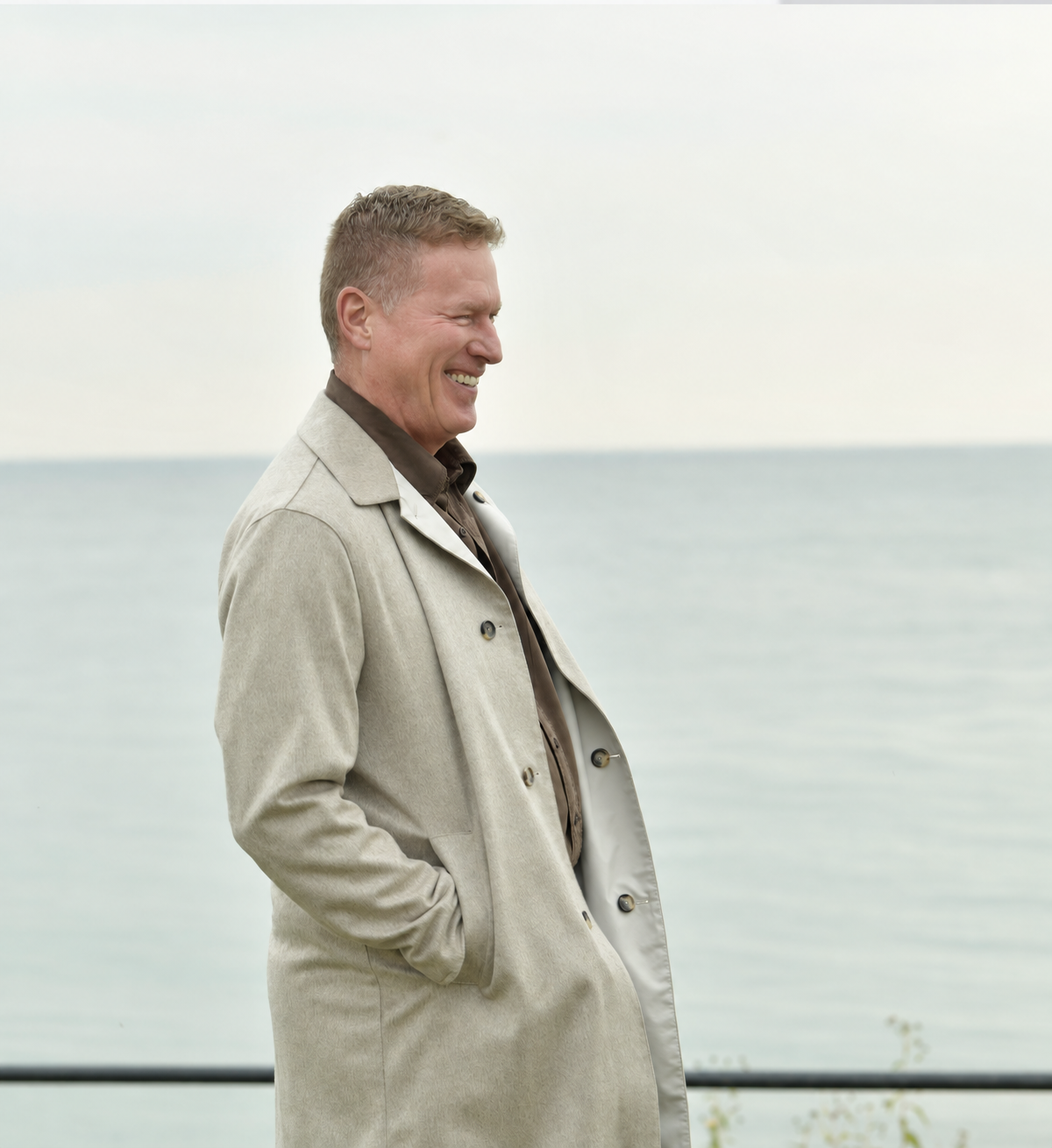 Ken Laird smiling beside the water.