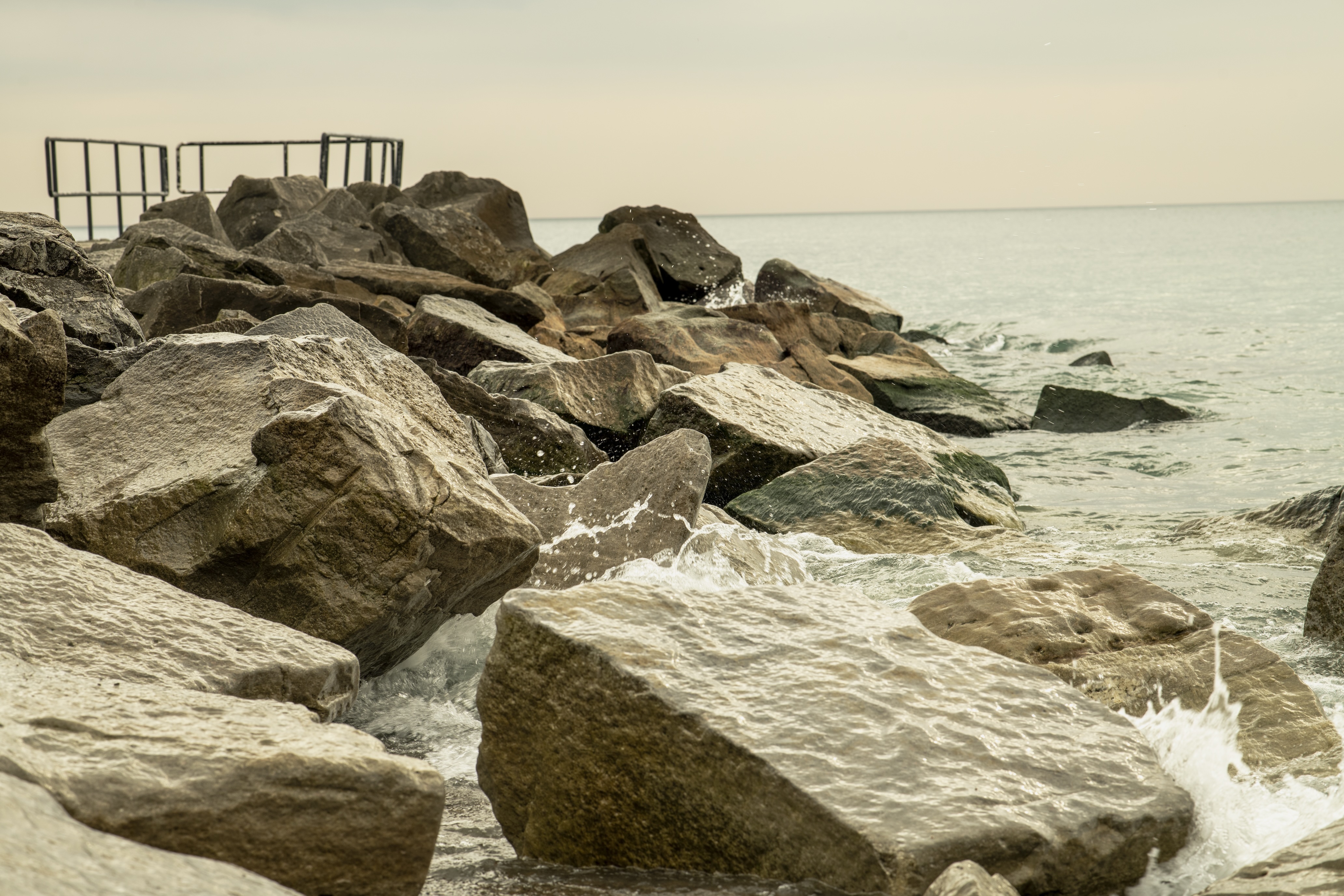 Waves meeting the rocks along the shore.