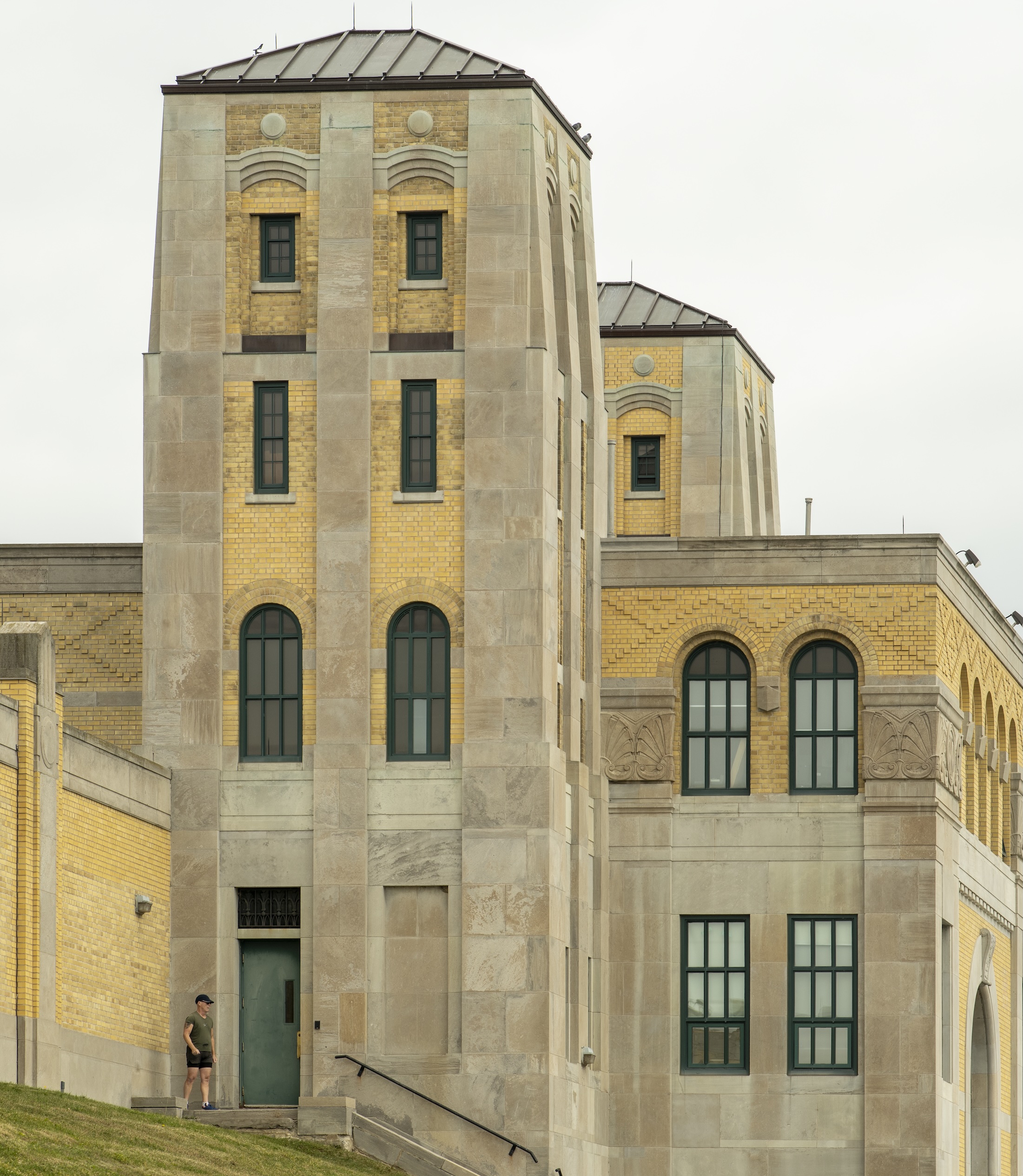 Pale stone and yellow brick architecture beside the waterfront.